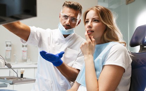Dentist explaining dental abscess treatment to a patient in Sand Springs
